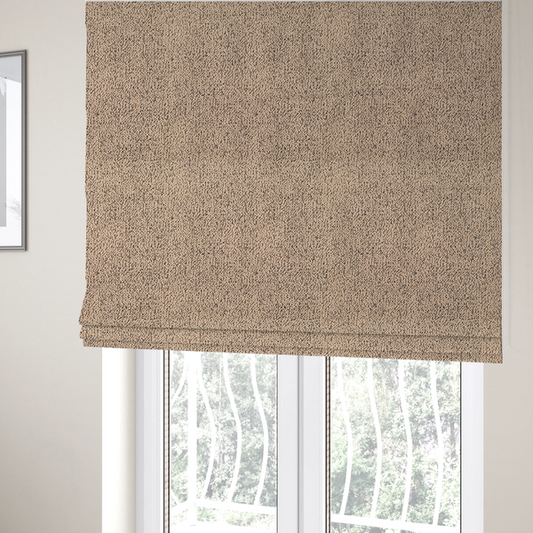 The fabric used to create these Roman blinds is a tan textured fabric with a dense, irregular black speckled pattern.