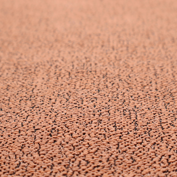 A terracotta orange textured fabric with a dense, irregular black speckled pattern.