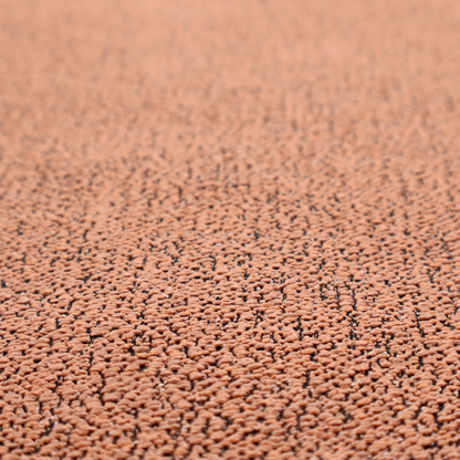 A terracotta orange textured fabric with a dense, irregular black speckled pattern.