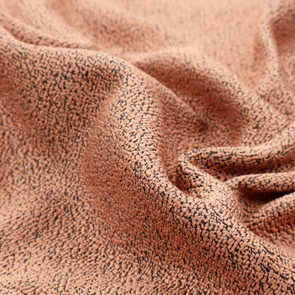 A terracotta orange textured fabric with a dense, irregular black speckled pattern.
