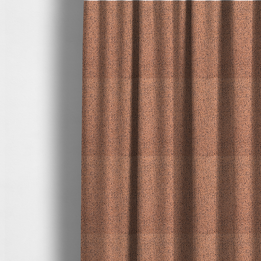 The fabric used to create these made-to-measure curtains is a terracotta orange textured fabric with a dense, irregular black speckled pattern.