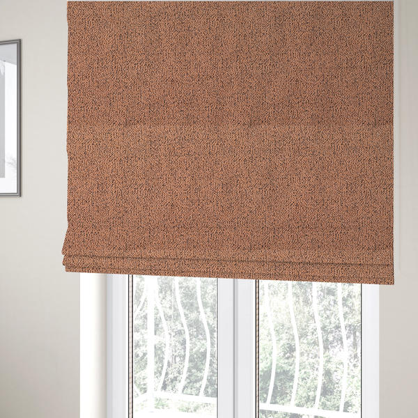 The fabric used to create these Roman blinds is a terracotta orange textured fabric with a dense, irregular black speckled pattern.