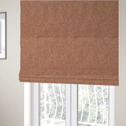 The fabric used to create these Roman blinds is a terracotta orange textured fabric with a dense, irregular black speckled pattern.
