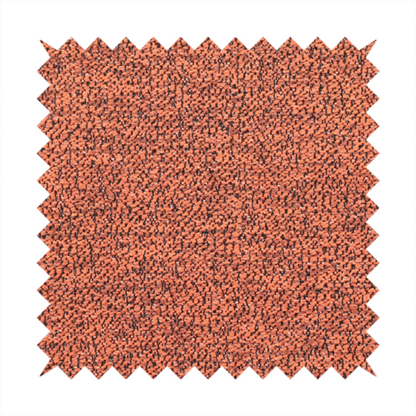 A coral textured fabric with a dense, irregular black speckled pattern.