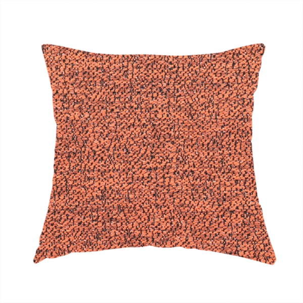 The fabric used to create this handmade cushion is a coral textured fabric with a dense, irregular black speckled pattern.