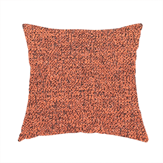 The fabric used to create this handmade cushion is a coral textured fabric with a dense, irregular black speckled pattern.