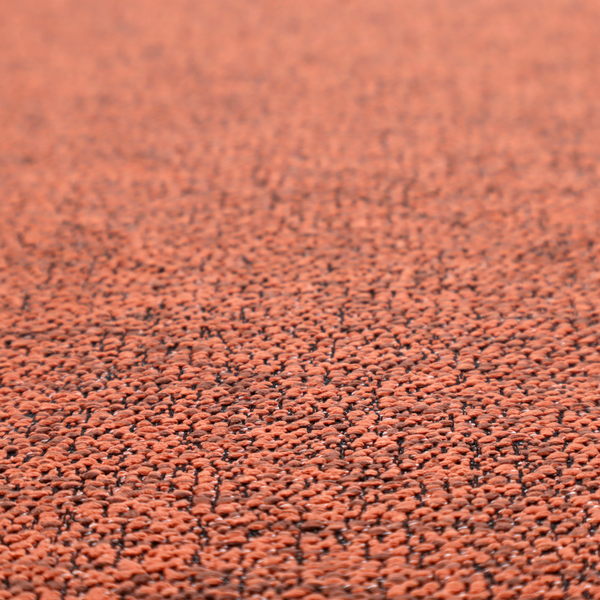 A coral textured fabric with a dense, irregular black speckled pattern.