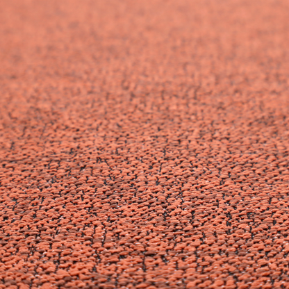 A coral textured fabric with a dense, irregular black speckled pattern.