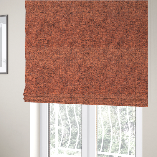 The fabric used to create these Roman blinds is a coral textured fabric with a dense, irregular black speckled pattern.