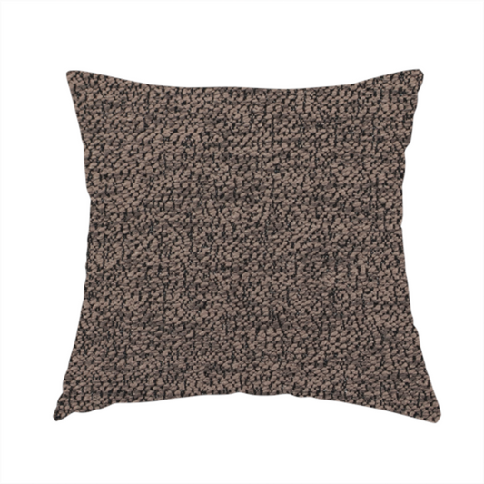 The fabric used to create these handmade cushions is a dark brown textured fabric with a dense, irregular black speckled pattern.
