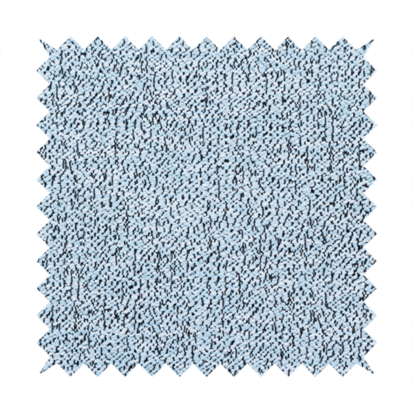 A light blue textured fabric with a dense, irregular black speckled pattern.