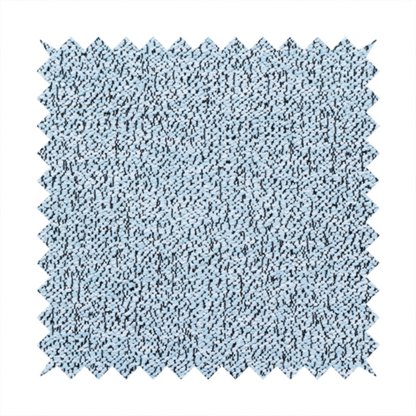 A light blue textured fabric with a dense, irregular black speckled pattern.