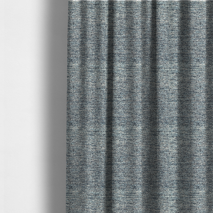 The fabric used to create these made-to-measure curtains is a medium blue textured fabric with a dense, irregular black speckled pattern.