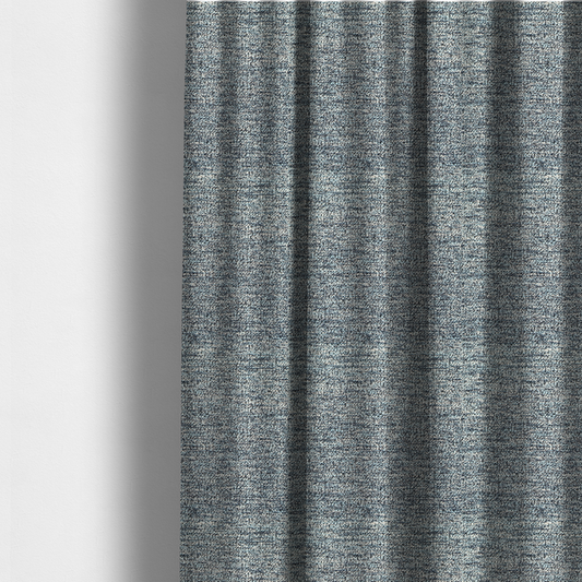 The fabric used to create these made-to-measure curtains is a medium blue textured fabric with a dense, irregular black speckled pattern.