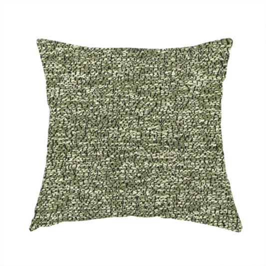 The fabric used to create these handmade cushions is a sage green textured fabric with a dense, irregular black speckled pattern.