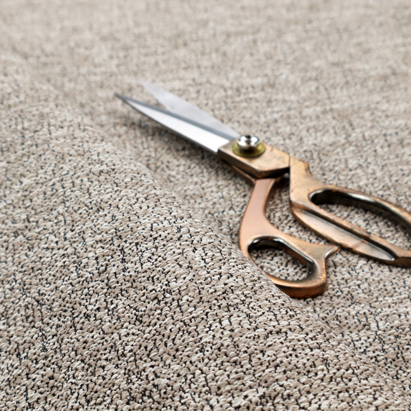 An ash brown textured fabric with a dense, irregular black speckled pattern.