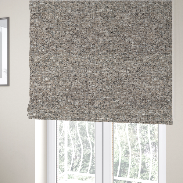 The fabric used to create these Roman blinds is a ash brown textured fabric with a dense, irregular black speckled pattern.