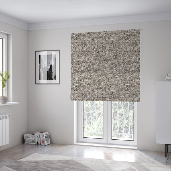 The fabric used to create these Roman blinds is a ash brown textured fabric with a dense, irregular black speckled pattern.