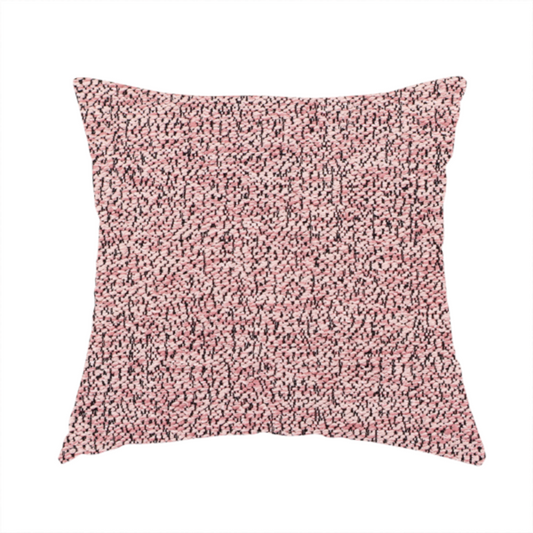 The fabric used to create this handmade cushion is a dusty rose textured fabric with a dense, irregular black speckled pattern.
