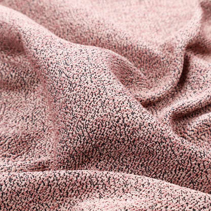 A dusty rose textured fabric with a dense, irregular black speckled pattern.
