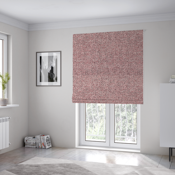 The fabric used to create these Roman blinds is a dusty rose textured fabric with a dense, irregular black speckled pattern.