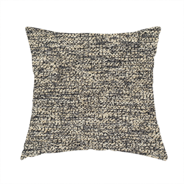 The fabric used to create this handmade cushion is a fossil grey and cream textured fabric with a dense, irregular speckled pattern.