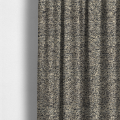 The fabric used to create these made-to-measure curtains is a fossil grey and cream textured fabric with a dense, irregular speckled pattern.