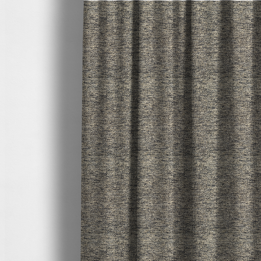The fabric used to create these made-to-measure curtains is a fossil grey and cream textured fabric with a dense, irregular speckled pattern.