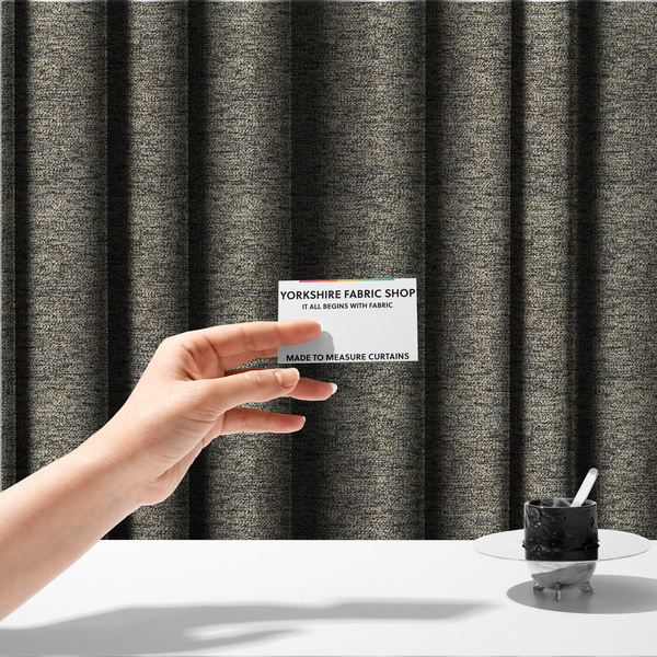 The fabric used to create these made-to-measure curtains is a fossil grey and cream textured fabric with a dense, irregular speckled pattern.