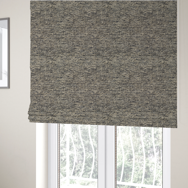 The fabric used to create these Roman blinds is a fossil grey and cream textured fabric with a dense, irregular speckled pattern.
