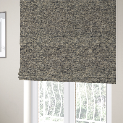 The fabric used to create these Roman blinds is a fossil grey and cream textured fabric with a dense, irregular speckled pattern.