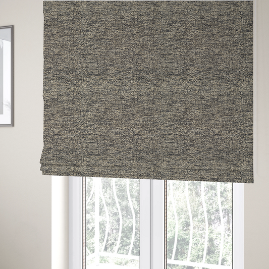 The fabric used to create these Roman blinds is a fossil grey and cream textured fabric with a dense, irregular speckled pattern.