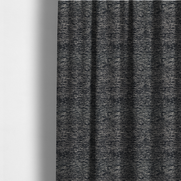 The fabric used to create these made-to-measure curtains is a black textured fabric with a dense, irregular cream and grey speckled pattern.