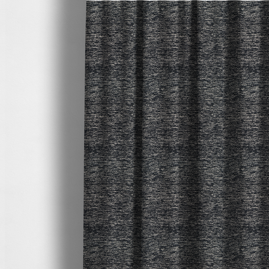 The fabric used to create these made-to-measure curtains is a black textured fabric with a dense, irregular cream and grey speckled pattern.