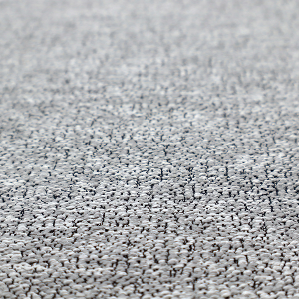 A light grey or silver textured fabric with an integrated black speckled motif, creating a cool-toned, high-contrast pebbled appearance.
