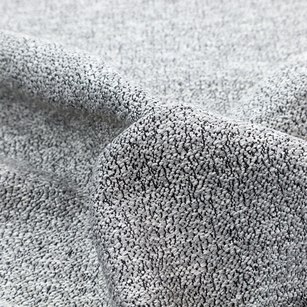A light grey or silver textured fabric with an integrated black speckled motif, creating a cool-toned, high-contrast pebbled appearance.
