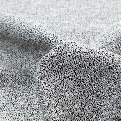 A light grey or silver textured fabric with an integrated black speckled motif, creating a cool-toned, high-contrast pebbled appearance.