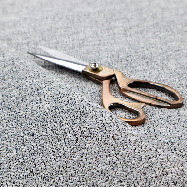 A light grey or silver textured fabric with an integrated black speckled motif, creating a cool-toned, high-contrast pebbled appearance.