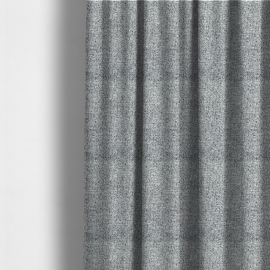 The fabric used to create these made-to-measure curtains is a light grey or silver textured fabric with an integrated black speckled motif, creating a cool-toned, high-contrast pebbled appearance.