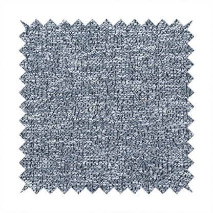 A silver-grey textured fabric with a dense, irregular black speckled pattern.