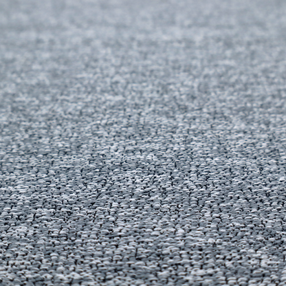A silver-grey textured fabric with a dense, irregular black speckled pattern.