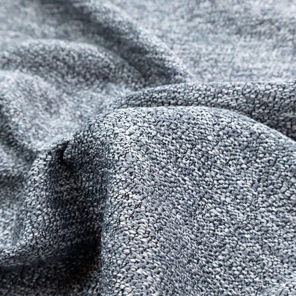 A silver-grey textured fabric with a dense, irregular black speckled pattern.