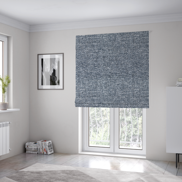 The fabric used to create these Roman blinds is a silver-grey textured fabric with a dense, irregular black speckled pattern.
