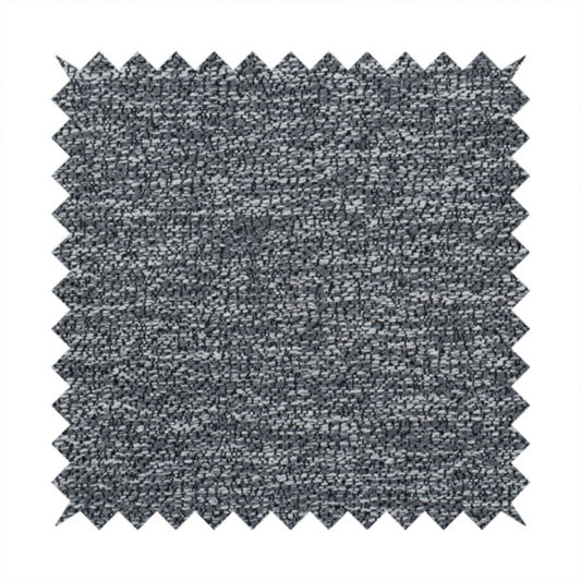 A charcoal grey textured fabric with a dense, irregular black and light grey speckled pattern, creating a high-contrast pebbled surface.