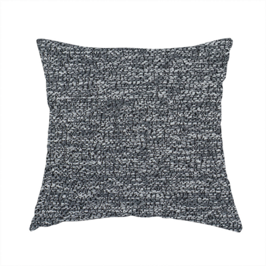 The fabric used to create this handmade cushion is a charcoal grey textured fabric with a dense, irregular black and light grey speckled pattern, creating a high-contrast pebbled surface.