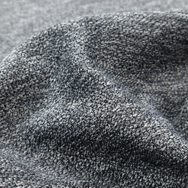 A charcoal grey textured fabric with a dense, irregular black and light grey speckled pattern, creating a high-contrast pebbled surface.
