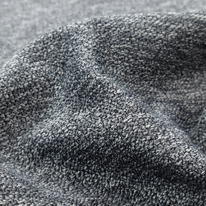 A charcoal grey textured fabric with a dense, irregular black and light grey speckled pattern, creating a high-contrast pebbled surface.