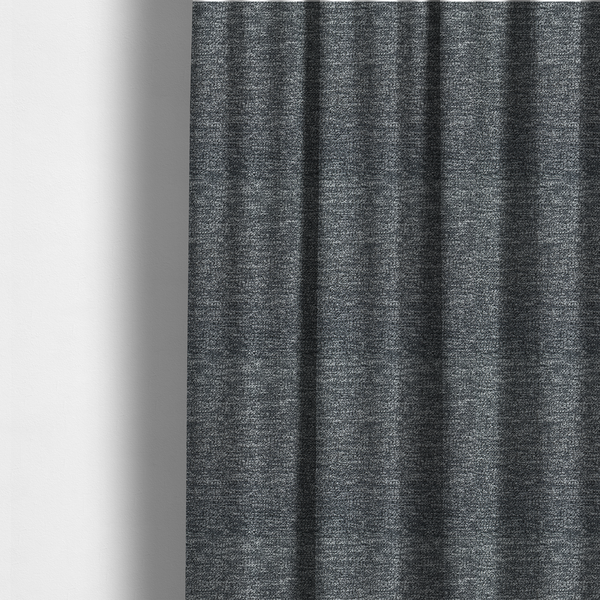 The fabric used to create these made-to-measure curtains is a charcoal grey textured fabric with a dense, irregular black and light grey speckled pattern, creating a high-contrast pebbled surface.
