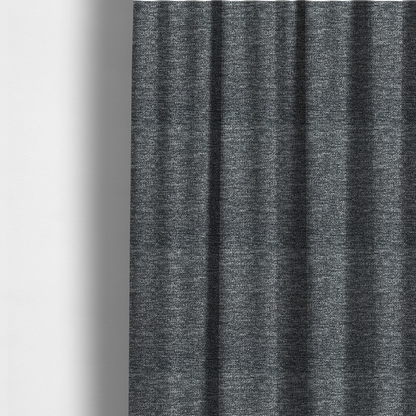 The fabric used to create these made-to-measure curtains is a charcoal grey textured fabric with a dense, irregular black and light grey speckled pattern, creating a high-contrast pebbled surface.