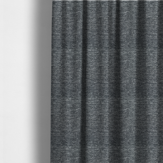 The fabric used to create these made-to-measure curtains is a charcoal grey textured fabric with a dense, irregular black and light grey speckled pattern, creating a high-contrast pebbled surface.